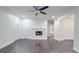 Living room with hardwood floors, white walls, fireplace, ceiling fan, and a large doorway at 809 N Ransom St, Gastonia, NC 28052