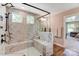 Spacious shower with white marbled walls, dual shower heads, a bench, and adjacent neutral-toned vanity at 8618 Frank Grier Rd # 58, Charlotte, NC 28215