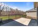 Backyard patio with an iron fence and natural wooded views at 9087 Treetop Nw Way, Concord, NC 28027