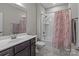 Bathroom featuring a shower over tub and a vanity with wood cabinets at 9087 Treetop Nw Way, Concord, NC 28027