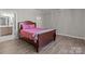 Bedroom with wood flooring and ample lighting, offering a calm retreat at 9087 Treetop Nw Way, Concord, NC 28027