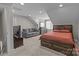 An angled view of the bedroom showing the bed, couch, dresser and tv at 9087 Treetop Nw Way, Concord, NC 28027