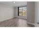 Bedroom with a view of the neighborhood and wood floors at 9087 Treetop Nw Way, Concord, NC 28027