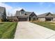 Exterior view of the home showcasing a driveway, a dormer window, and well-maintained landscaping at 9087 Treetop Nw Way, Concord, NC 28027