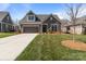 Exterior view of the home with a dark brown garage, a dormer window, and well-maintained landscaping at 9087 Treetop Nw Way, Concord, NC 28027