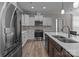 Well-equipped kitchen featuring stainless steel appliances and a central island at 9087 Treetop Nw Way, Concord, NC 28027