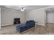 Cozy living room with wood floors, a ceiling fan, and a sleek entertainment center at 9087 Treetop Nw Way, Concord, NC 28027