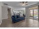 Open-concept living room featuring modern finishes, hardwood floors, and sliding doors to a balcony at 9087 Treetop Nw Way, Concord, NC 28027