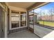 View of the covered patio featuring gray siding, window, and a screened-in patio section at 9087 Treetop Nw Way, Concord, NC 28027