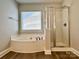 Modern bathroom featuring a large soaking tub and a glass-enclosed shower at 9419 Seamill Rd, Charlotte, NC 28278