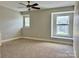 Cozy bedroom with carpeted floors, ceiling fan, and sunlit windows at 9419 Seamill Rd, Charlotte, NC 28278
