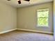 This spacious bedroom showcases a window offering natural light and carpeted flooring at 9419 Seamill Rd, Charlotte, NC 28278