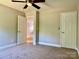 Bedroom showcasing carpeted flooring, neutral paint, and white doors at 9419 Seamill Rd, Charlotte, NC 28278