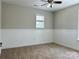 Neutral bedroom featuring carpeted floor, modern ceiling fan and bright window at 9419 Seamill Rd, Charlotte, NC 28278