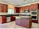 Spacious kitchen features wooden cabinets, stainless steel appliances, granite countertops, and a center island at 9419 Seamill Rd, Charlotte, NC 28278