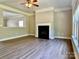 Stylish living room featuring hardwood floors, a fireplace, and an open layout at 9419 Seamill Rd, Charlotte, NC 28278