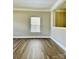 Inviting living room with hardwood floors, white trim, and large window at 9419 Seamill Rd, Charlotte, NC 28278