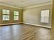 Spacious living room featuring hardwood floors, large windows, and ample natural light at 9419 Seamill Rd, Charlotte, NC 28278