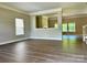 Open-concept living room boasts hardwood floors, bright windows, and neutral walls at 9419 Seamill Rd, Charlotte, NC 28278