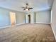 A spacious primary bedroom featuring bright windows, trey ceiling, and fan at 9419 Seamill Rd, Charlotte, NC 28278