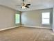 Expansive primary bedroom features large windows, trey ceiling, and ceiling fan at 9419 Seamill Rd, Charlotte, NC 28278