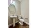 Stylish powder room with pedestal sink, modern fixtures, and tile flooring at 9419 Seamill Rd, Charlotte, NC 28278