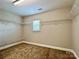 Spacious walk-in closet with carpet and multiple rows of shelves for optimal storage at 9419 Seamill Rd, Charlotte, NC 28278