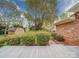 Beautiful backyard featuring a spacious deck, mature trees, colorful flowers, and convenient storage shed at 9539 Errington Ln, Mint Hill, NC 28227