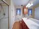 Bathroom featuring a walk-in shower, double vanity, and unique wallpaper at 9539 Errington Ln, Mint Hill, NC 28227