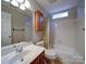 Bathroom featuring a sink, toilet, and bathtub with shower at 9539 Errington Ln, Mint Hill, NC 28227