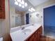 Bathroom with double sinks, a large mirror and a shower with a glass door at 9539 Errington Ln, Mint Hill, NC 28227