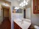 Bathroom with a sink, mirror, and doorway leading to the hallway at 9539 Errington Ln, Mint Hill, NC 28227