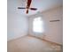Bedroom with ceiling fan and a window with sheer curtains at 9539 Errington Ln, Mint Hill, NC 28227