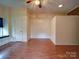 Bonus room showcasing hardwood floors, a window seat, and a ceiling fan at 9539 Errington Ln, Mint Hill, NC 28227