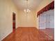 Dining room featuring hardwood floors and classic chandelier at 9539 Errington Ln, Mint Hill, NC 28227