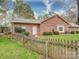 Charming one-story brick home with a well-maintained lawn and a classic white front door behind a picket fence at 9539 Errington Ln, Mint Hill, NC 28227