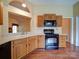 Eat-in kitchen featuring oak cabinets and black appliances at 9539 Errington Ln, Mint Hill, NC 28227