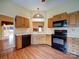 Eat-in kitchen featuring oak cabinets and black appliances at 9539 Errington Ln, Mint Hill, NC 28227