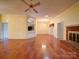 Spacious living room featuring hardwood floors and a brick fireplace at 9539 Errington Ln, Mint Hill, NC 28227
