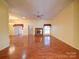 Expansive living room featuring wood floors and a cozy brick fireplace at 9539 Errington Ln, Mint Hill, NC 28227