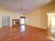 Spacious living room featuring hardwood floors and a cozy brick fireplace at 9539 Errington Ln, Mint Hill, NC 28227