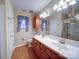 Main bathroom featuring a double vanity, a walk-in shower, and unique wallpaper at 9539 Errington Ln, Mint Hill, NC 28227