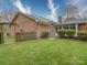 Brick home backyard with a screened-in porch and verdant lawn, fenced at 9539 Errington Ln, Mint Hill, NC 28227