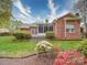 The rear of the home displays a brick exterior, screened porch, patio, and verdant landscaped backyard at 9539 Errington Ln, Mint Hill, NC 28227