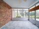 Bright sunroom with brick wall and multiple windows offering serene outdoor views at 9539 Errington Ln, Mint Hill, NC 28227