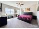 Bright bedroom with a large window, carpet, and an accent wall art at 9677 Garamont Nw Pkwy, Concord, NC 28027