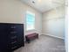 Bedroom walk-in closet featuring shelving and a window for natural light at 9677 Garamont Nw Pkwy, Concord, NC 28027