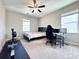 Bedroom with large window, ceiling fan and space for a home office setup at 9677 Garamont Nw Pkwy, Concord, NC 28027