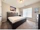 Comfortable bedroom with a large bed and natural light from the window, creating a serene and inviting space at 9677 Garamont Nw Pkwy, Concord, NC 28027