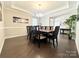 Elegant dining room features hardwood flooring, a chandelier, and ample seating at 9677 Garamont Nw Pkwy, Concord, NC 28027